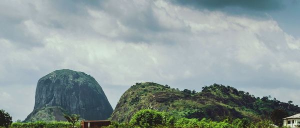 Low angle view of mountain against cloudy sky