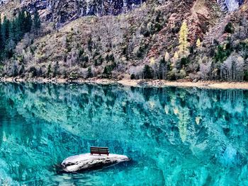 Boat on sea against mountain