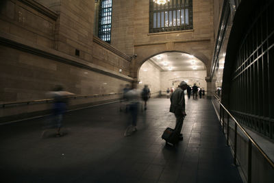 People walking in corridor of building