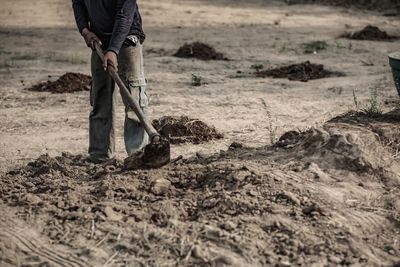 Low section of man working on land