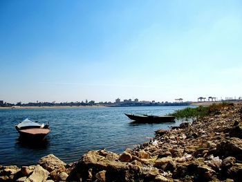 Sailboats moored on nile river  against clear sky