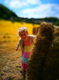 Girl playing with arms raised on field