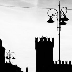 Silhouette lamp post against clear sky