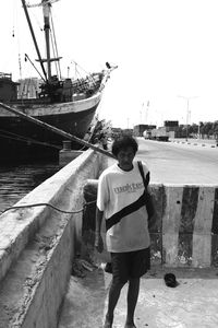 Rear view of man standing on sea against sky