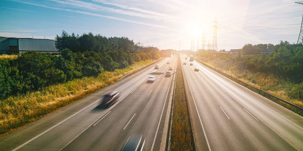 Cars on road in city against sky