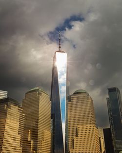 Freedom tower during golden hour against dramatic clouds