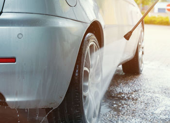 Close-up of wet car on street