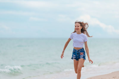 Young woman standing at beach