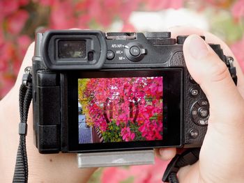 Midsection of woman photographing with camera phone