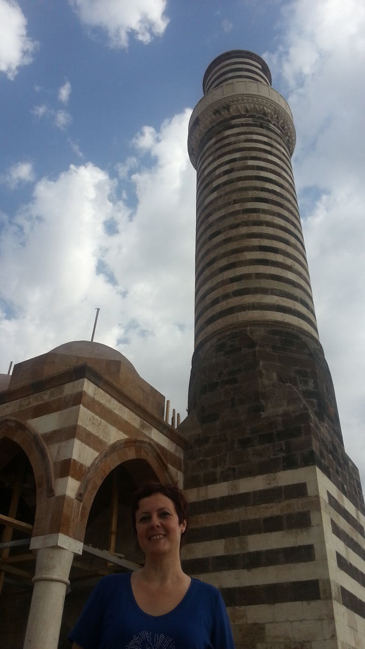 architecture, built structure, building exterior, sky, low angle view, cloud - sky, tower, lifestyles, famous place, travel destinations, tourism, cloud, travel, leisure activity, city, international landmark, day, casual clothing