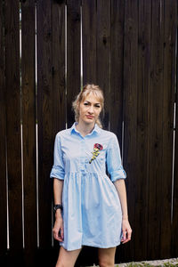 Portrait of smiling girl standing on wood