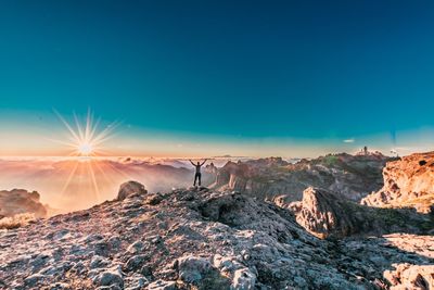 Scenic view of mountains against blue sky during sunset