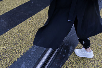 Low section of woman standing on tiled floor