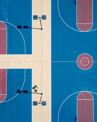 High angle view of man on sports court during sunny day