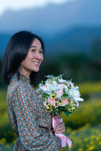 Young woman holding flower bouquet