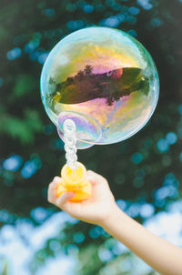 Close-up of woman holding bubbles