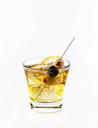 Close-up of drink on ice against white background