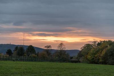 Scenic view of field against sky during sunset