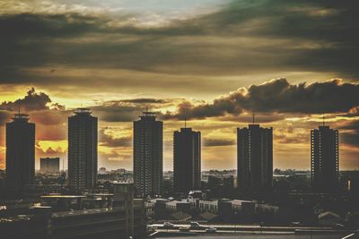 View of cityscape against cloudy sky during sunset