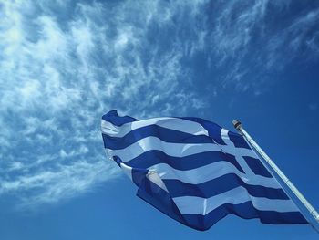 Low angle view of flag against blue sky