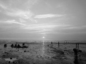 People on beach against sky