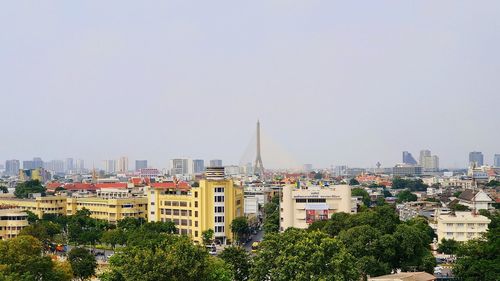 Buildings in city against clear sky