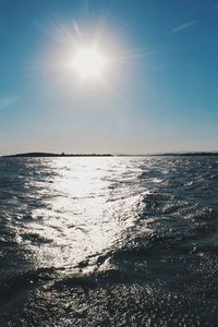 Scenic view of sea against sky on sunny day