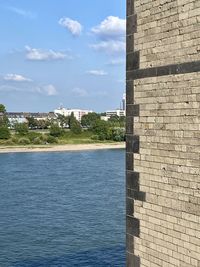 Scenic view of sea by building against sky