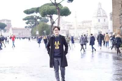 Portrait of man standing in city