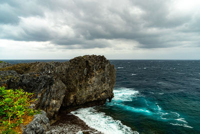 Rock formations by sea against sky