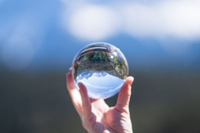 Close-up of hand holding crystal ball