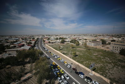 High angle view of vehicles on road against sky