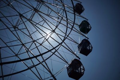 Low angle view of ferris wheel against sky