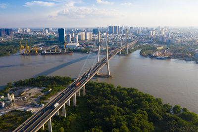 High angle view of bridge over river by buildings in city