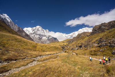 People hiking against sky