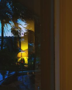 Illuminated building seen through window