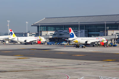 View of airplane on airport runway against sky