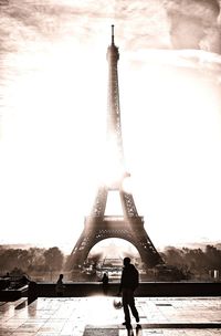 Full length of man and woman tower against sky in city