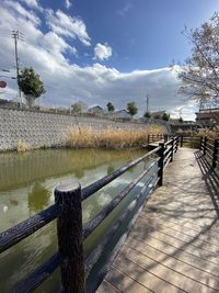 Bridge over canal against sky