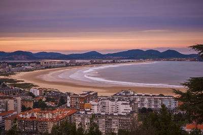 High angle view of townscape by sea against sky