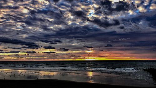 Scenic view of sea against dramatic sky