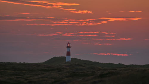 Lighthouse against sky during sunset