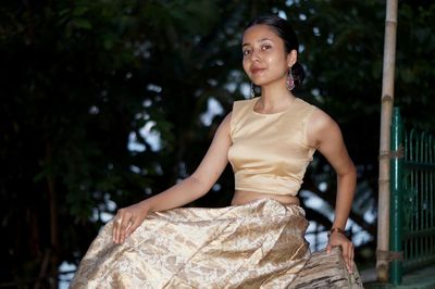 Portrait of woman against tree