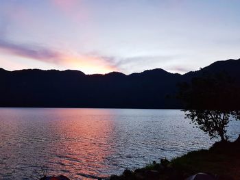 Scenic view of lake against sky during sunset