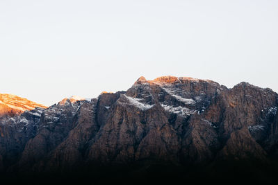 Rock formations on mountain against clear sky