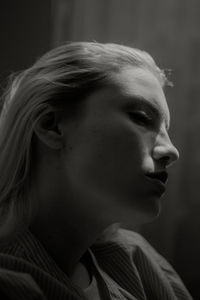 Close-up of woman sitting in darkroom