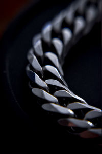 Close-up of spiral metal against black background