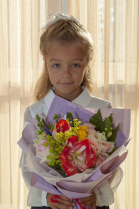 Portrait of girl holding flowers