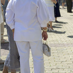 Rear view of people walking on street