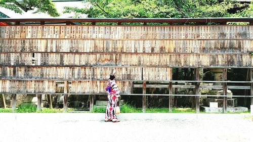 Full length of woman standing by railing